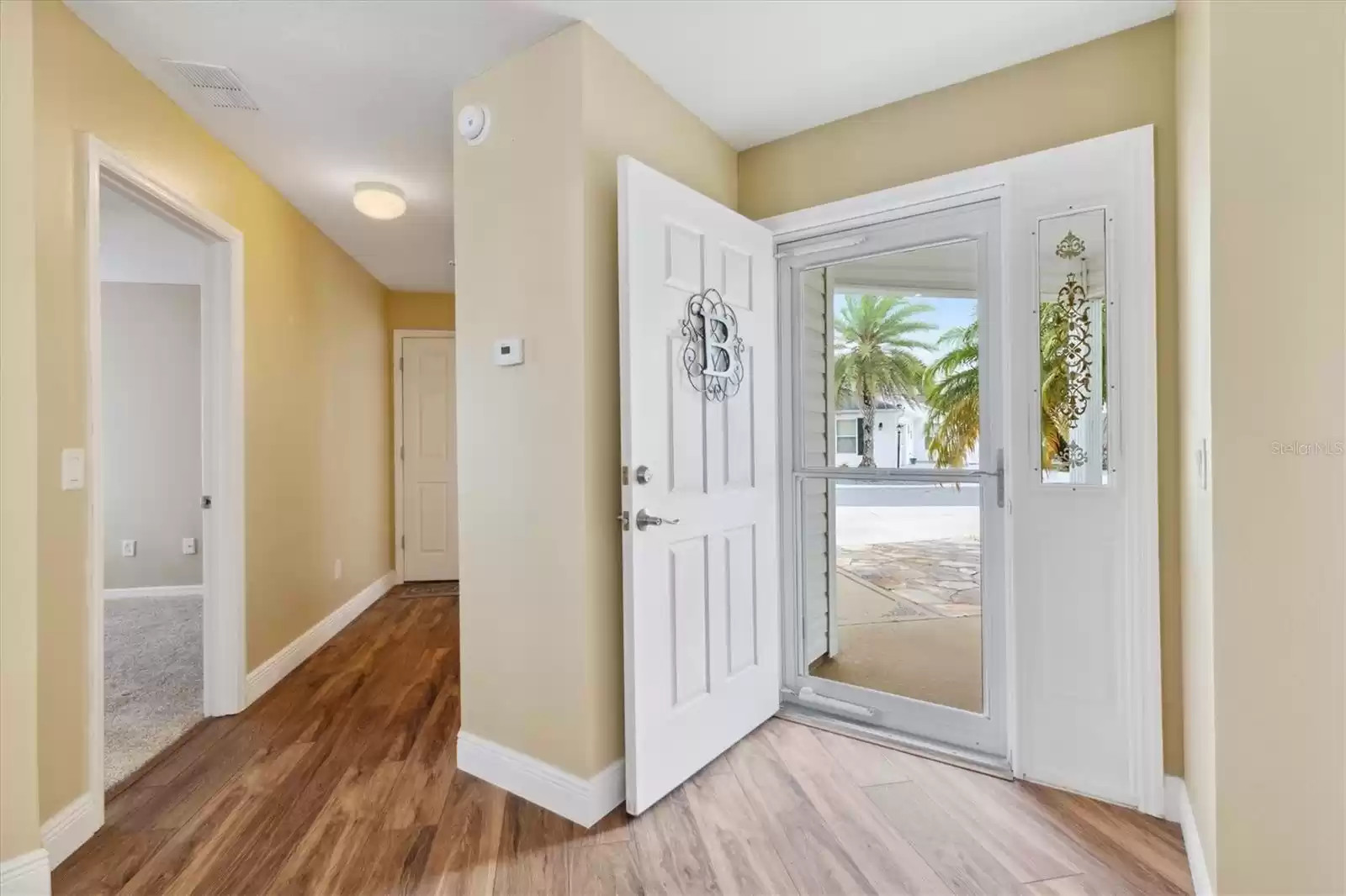 YOU ARE WELCOMED TO THE SPACIOUS FOYER WITH GORGEOUS ENGINEERED HARDWOOD FLOORS