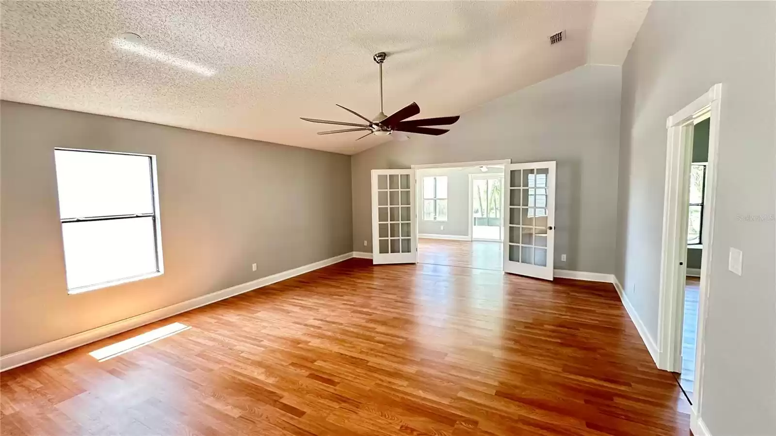 Large Livingroom with Vaulted Ceiling. French Doors open to Florida room!