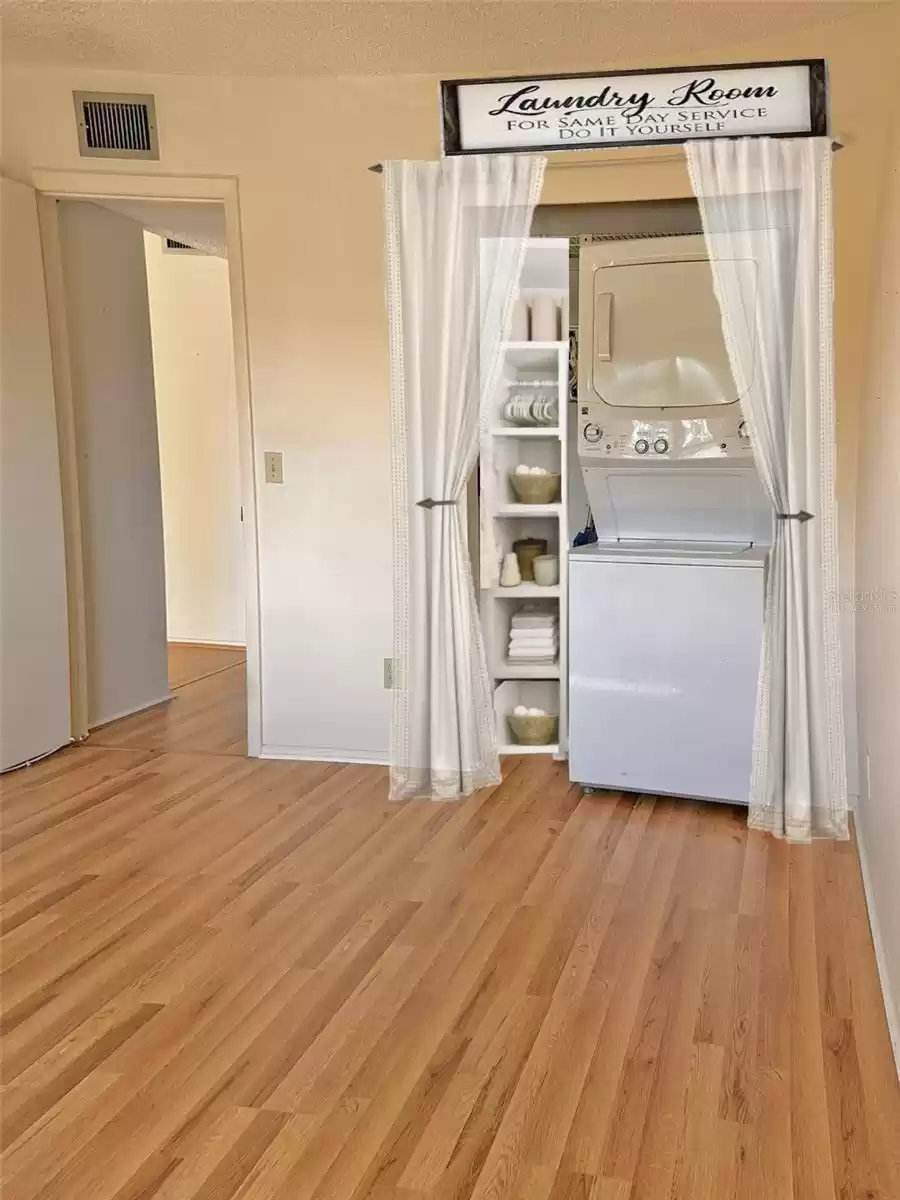 (virtually staged drape ) washer and dryer inside closet Bedroom 2