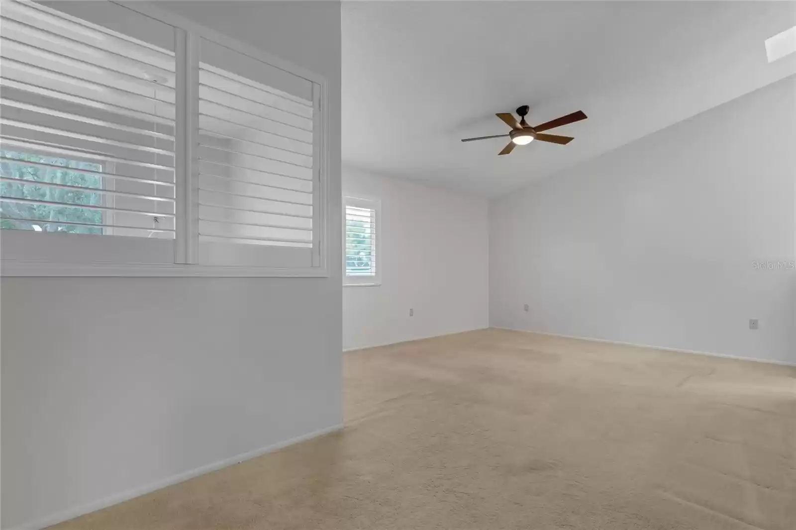 Primary bedroom with vaulted ceilings