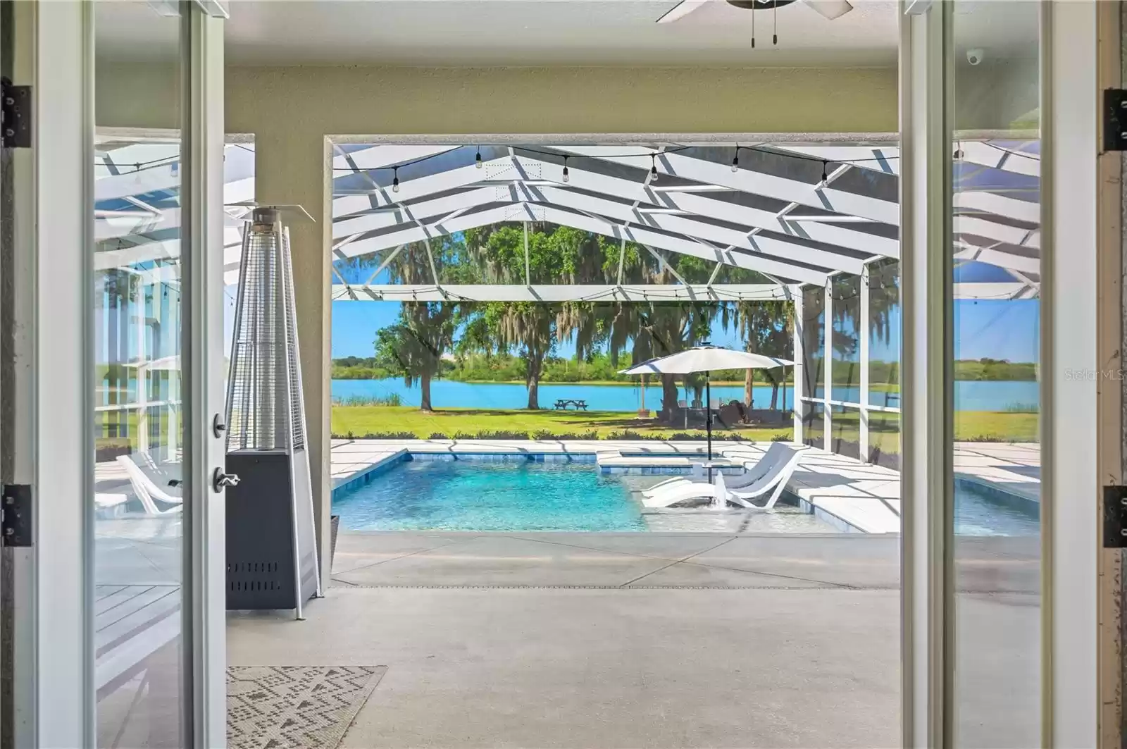 Primary Bedroom with french doors to pool and Lake views!