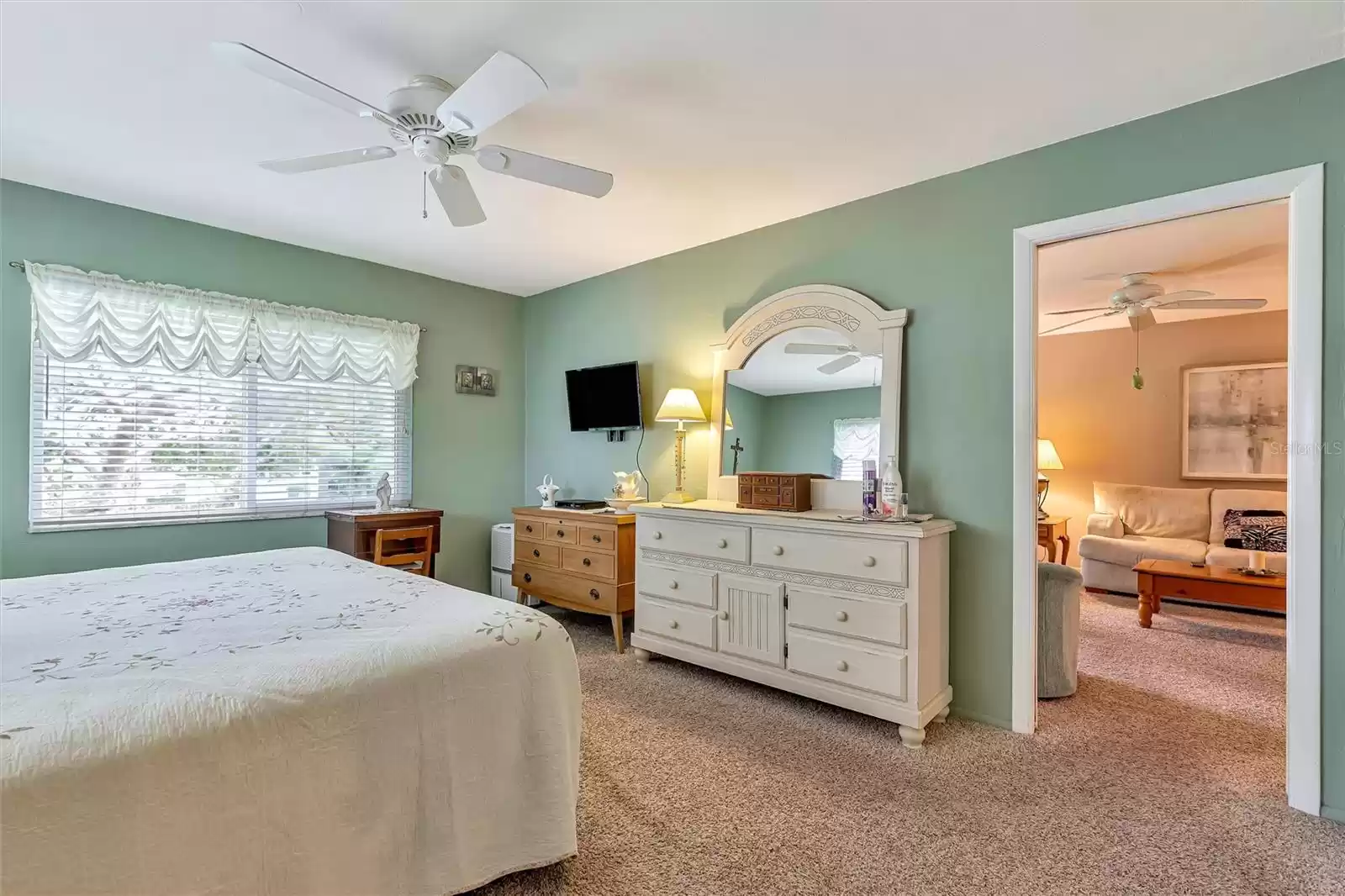 Primary bedroom with pocket door to living room