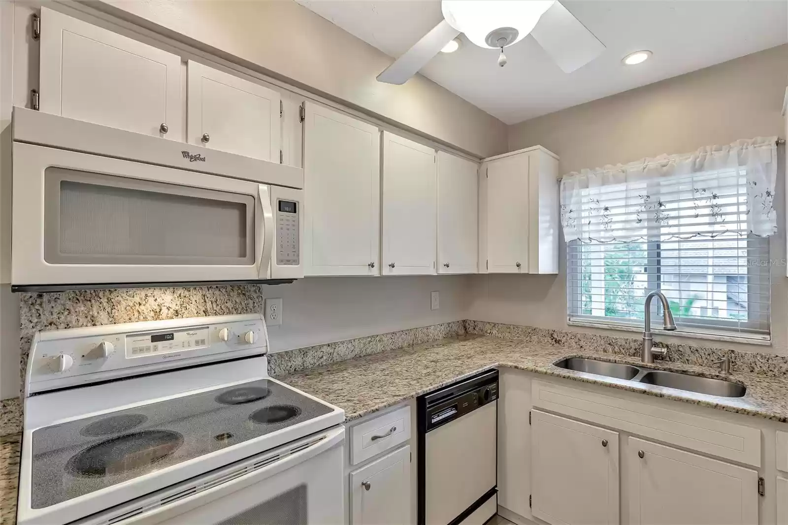 Light, bright kitchen with granite counters