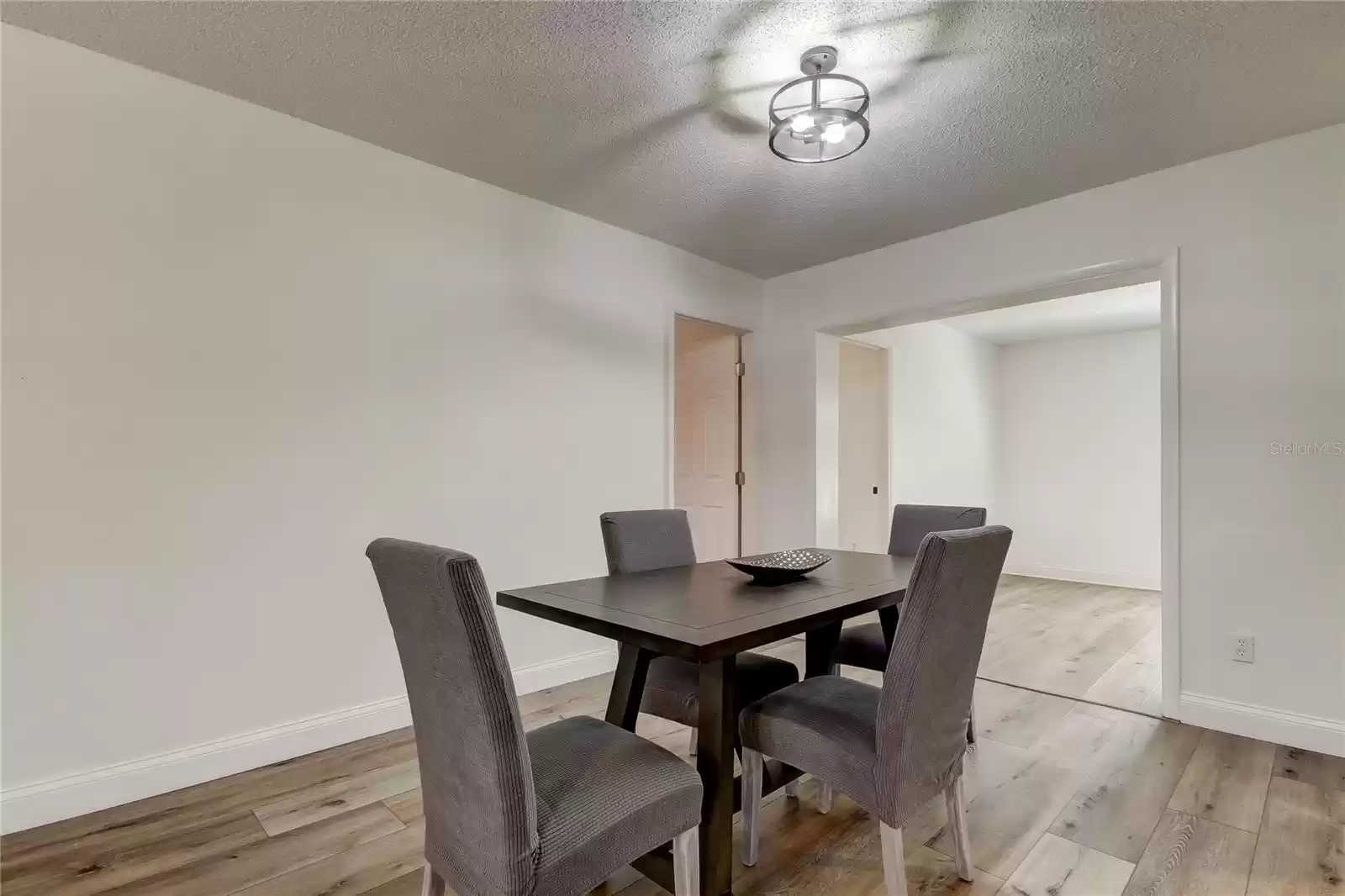 Dining area with primary bedroom to left and family room behind.