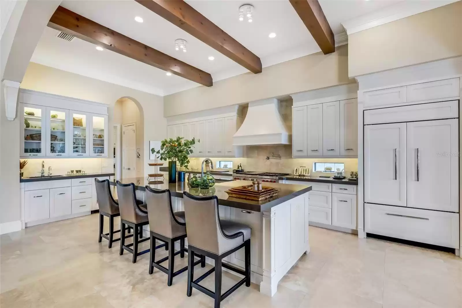 From the custom cabinetry, ceiling beams, smooth surface countertops, and great lighting.