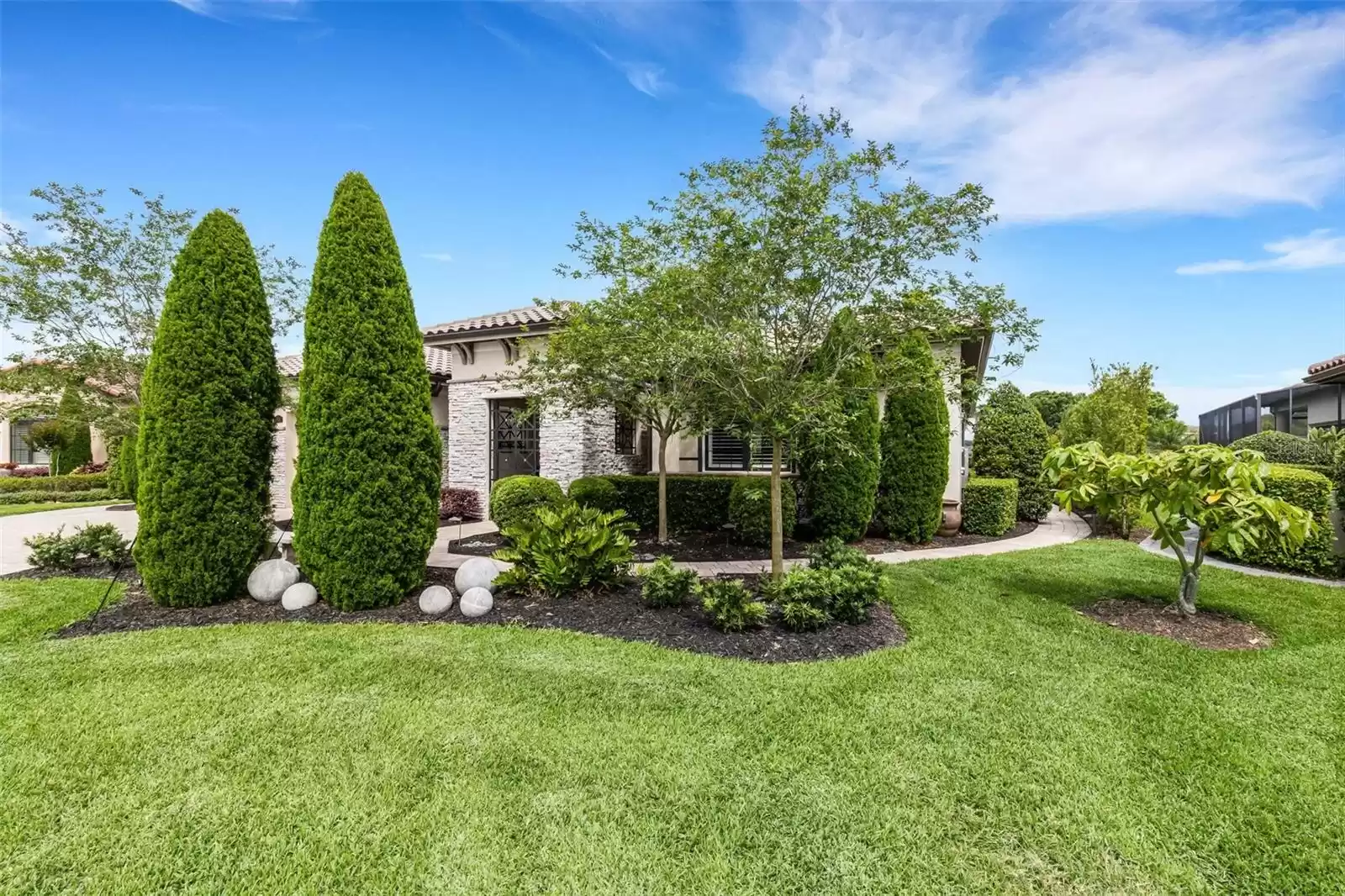 Lushly landscaped for maximum curb appeal and privacy