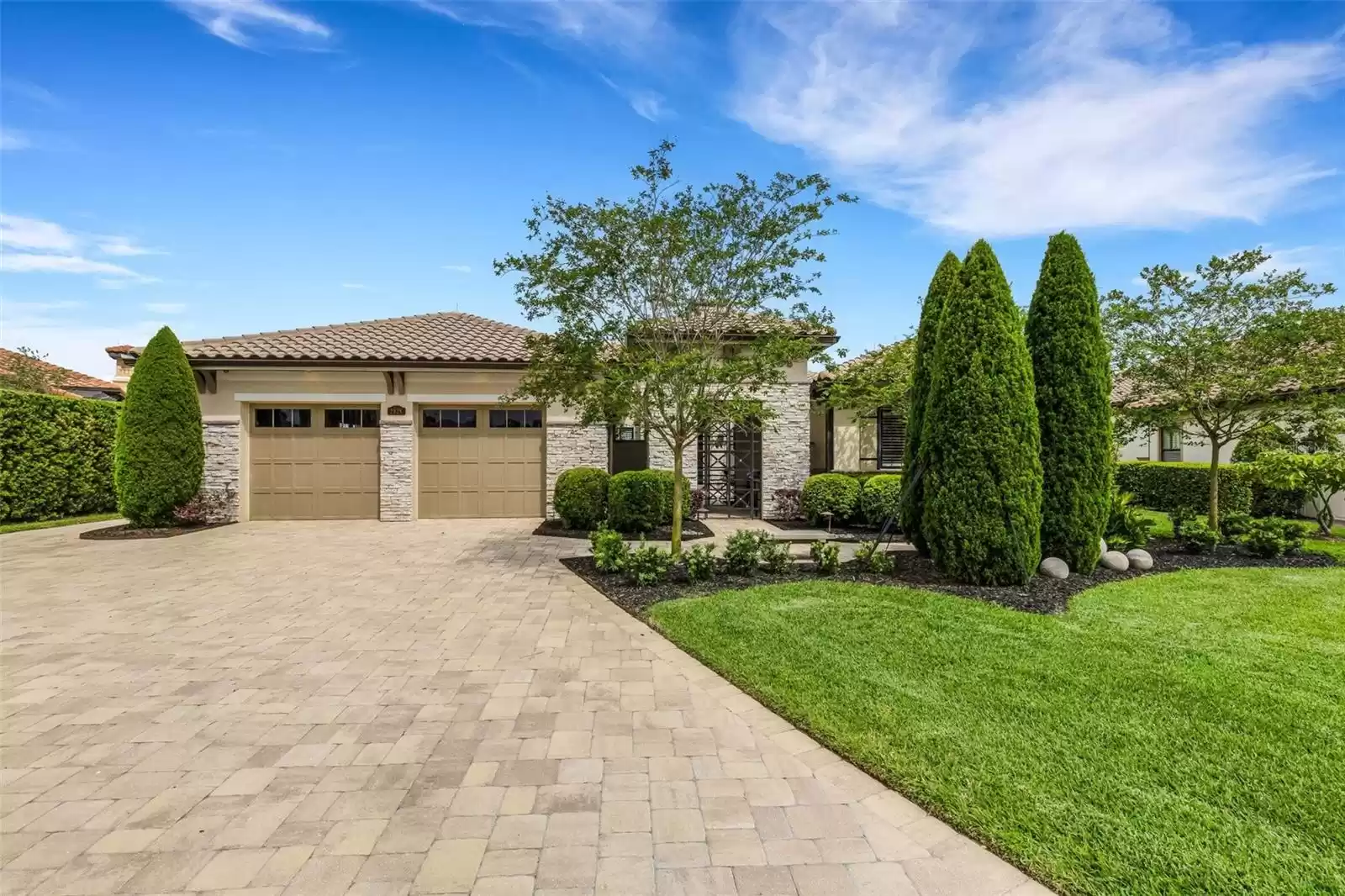 Oversize brick paver driveway and walkways on both sides of the home