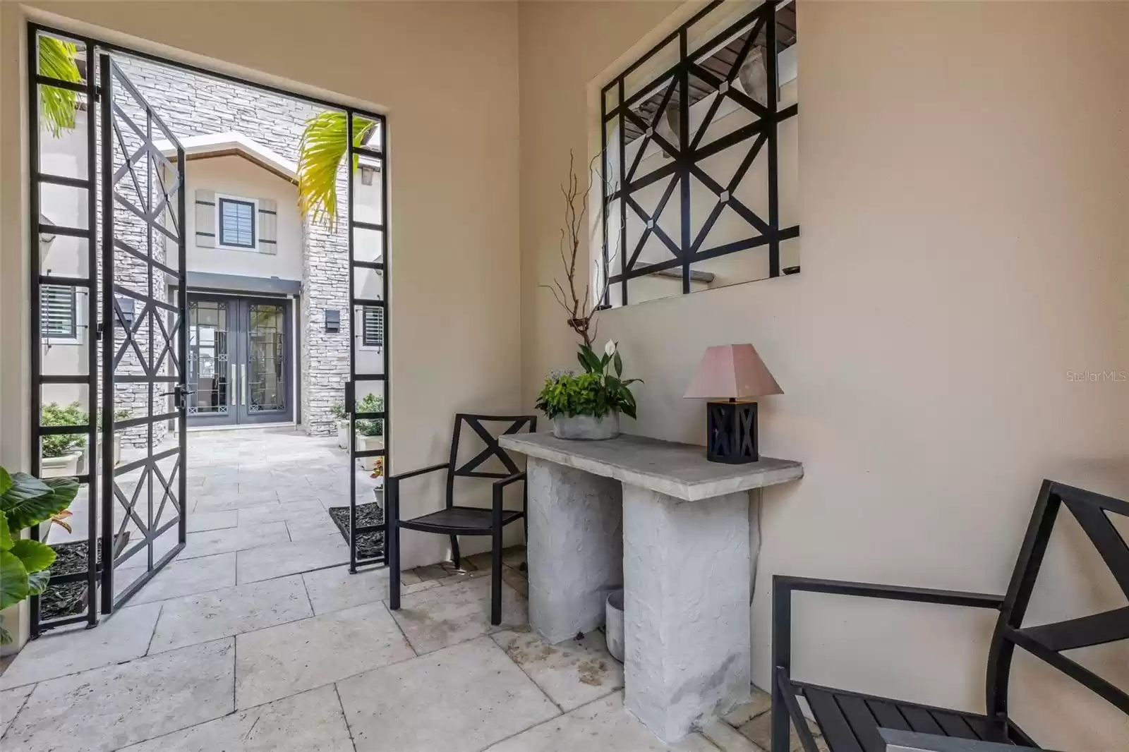 Enter through dual custom iron gates into the zen-like interior courtyard