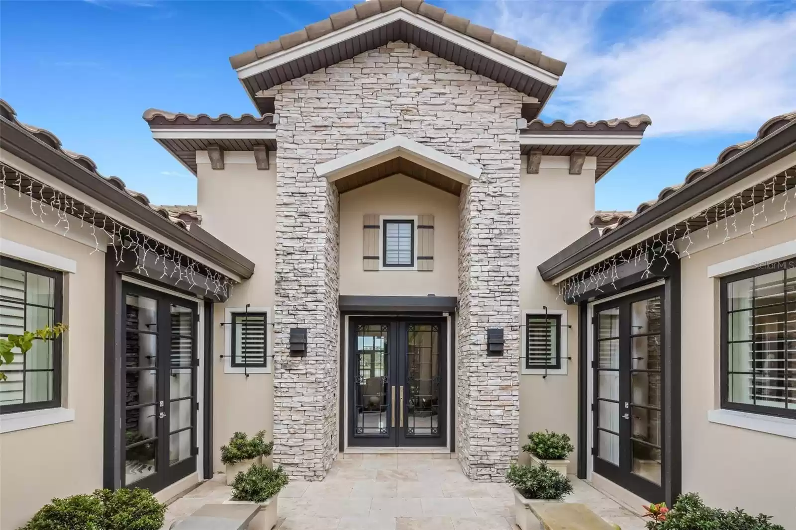 From this courtyard three sets of double doors lead into the home.