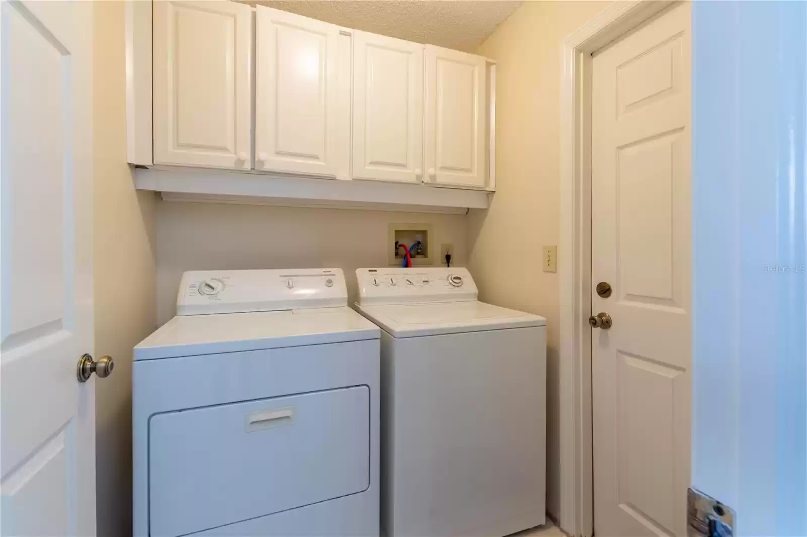 Laundry room with door to garage