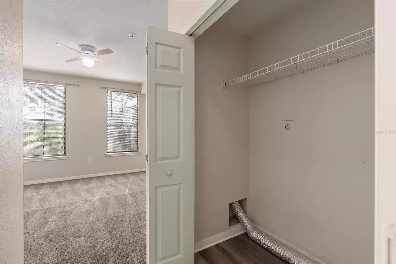 entry to bedroom with laundry closet to right