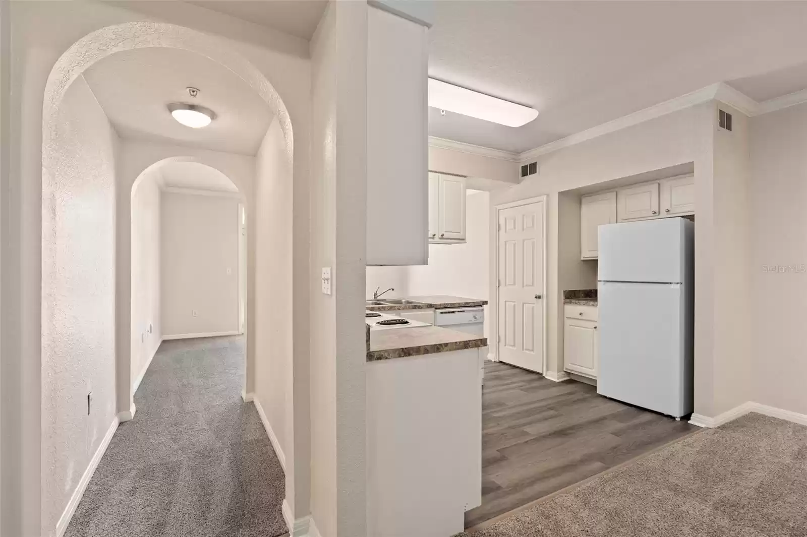 View from front door to kitchen/dining area and hallway to living room