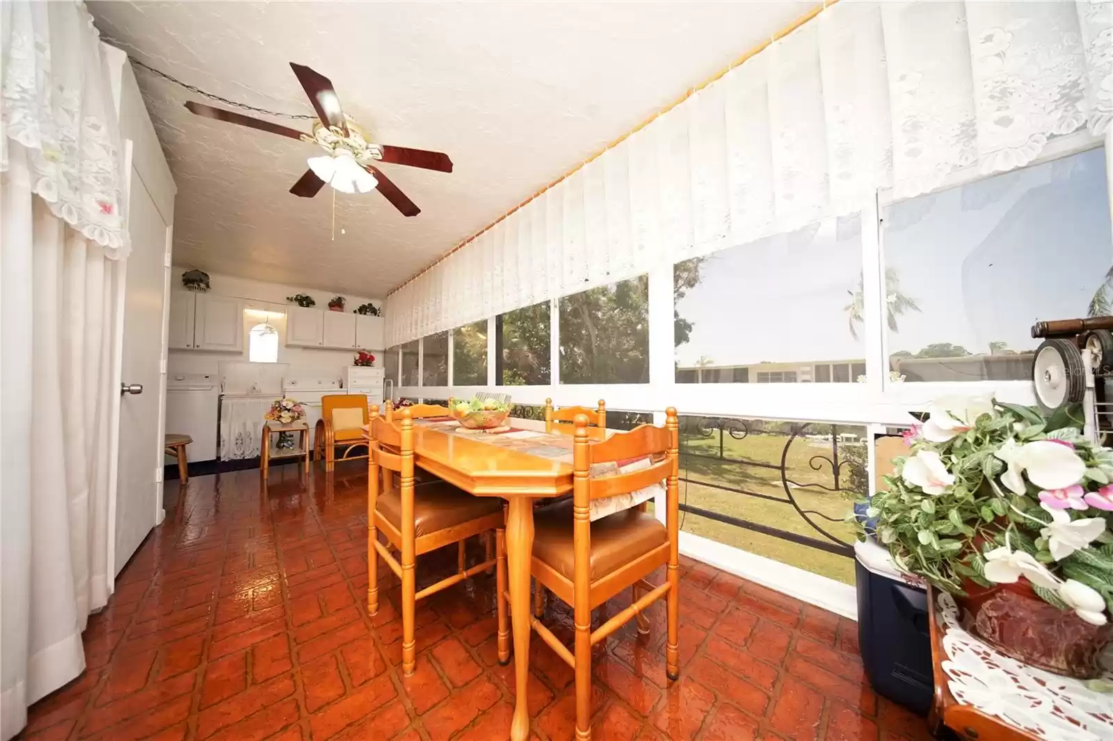 Florida room with custom built in enclose around Central AC air-handler visible to the left.