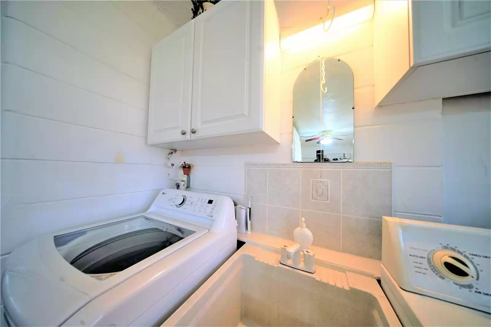 DRYER AND NEWER TOP-LOAD WASHER visible in Florida room