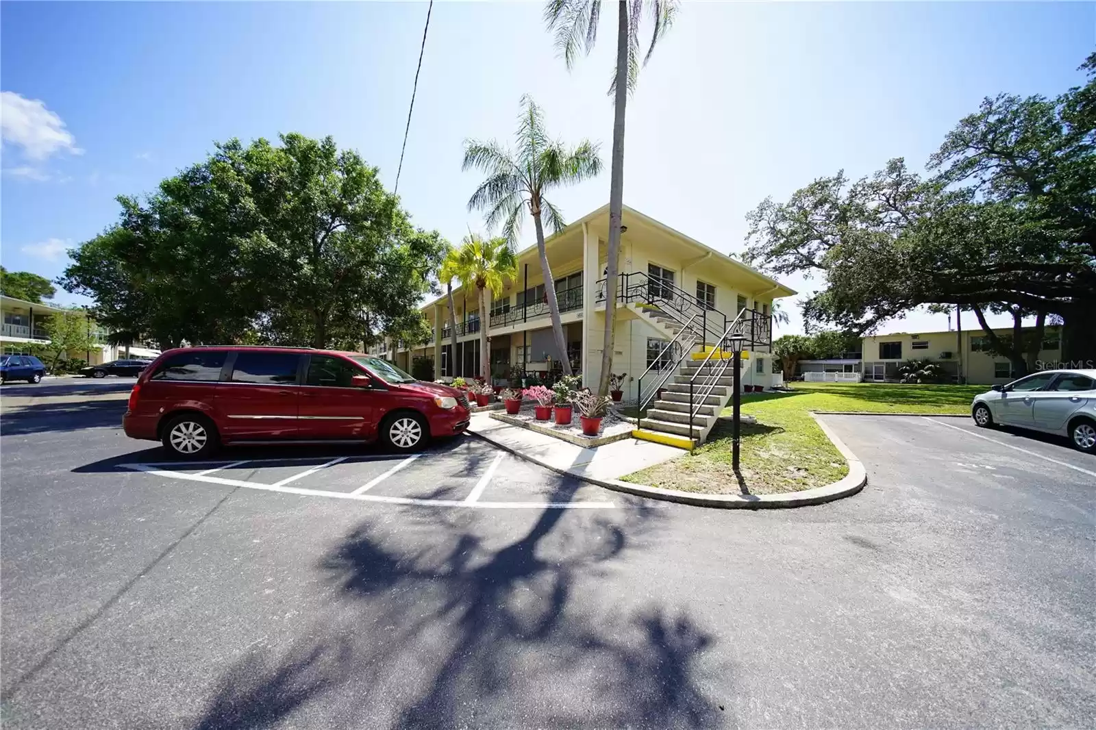 2-bedroom condo in PET FRIENDLY complex with assigned Parking lot visible to the right.