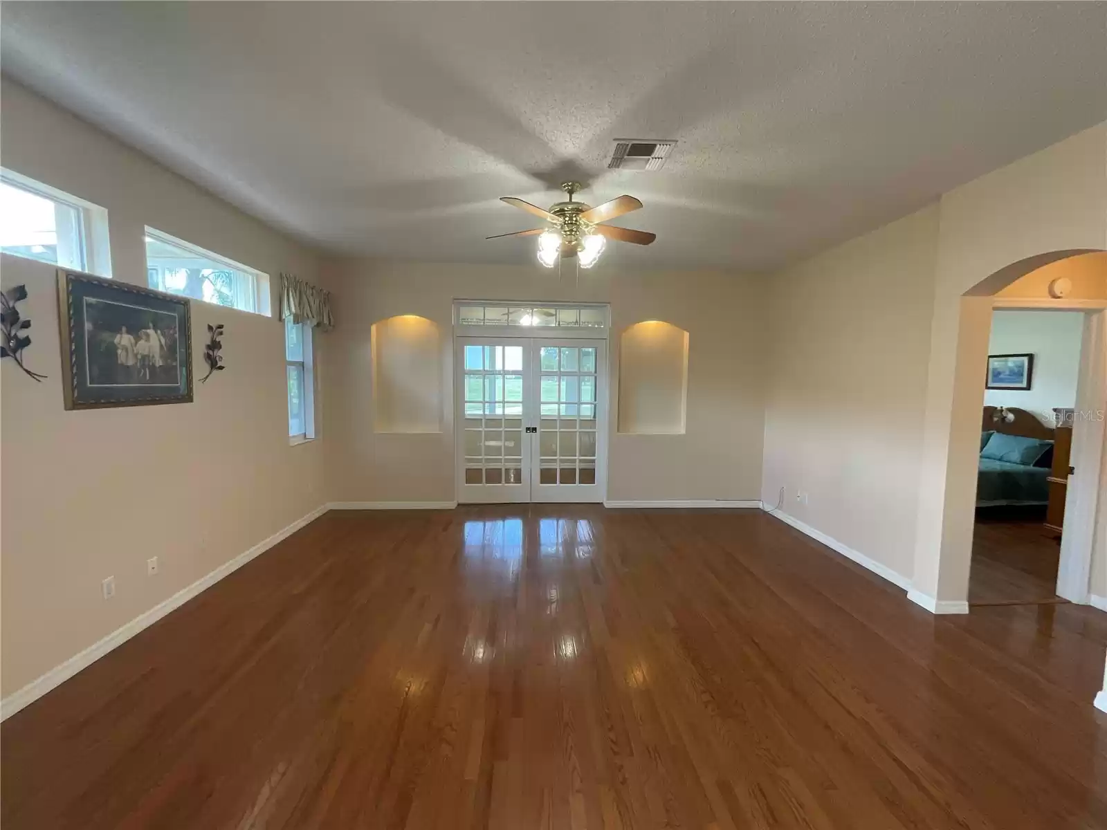 Living room with french doors closing off bonus area