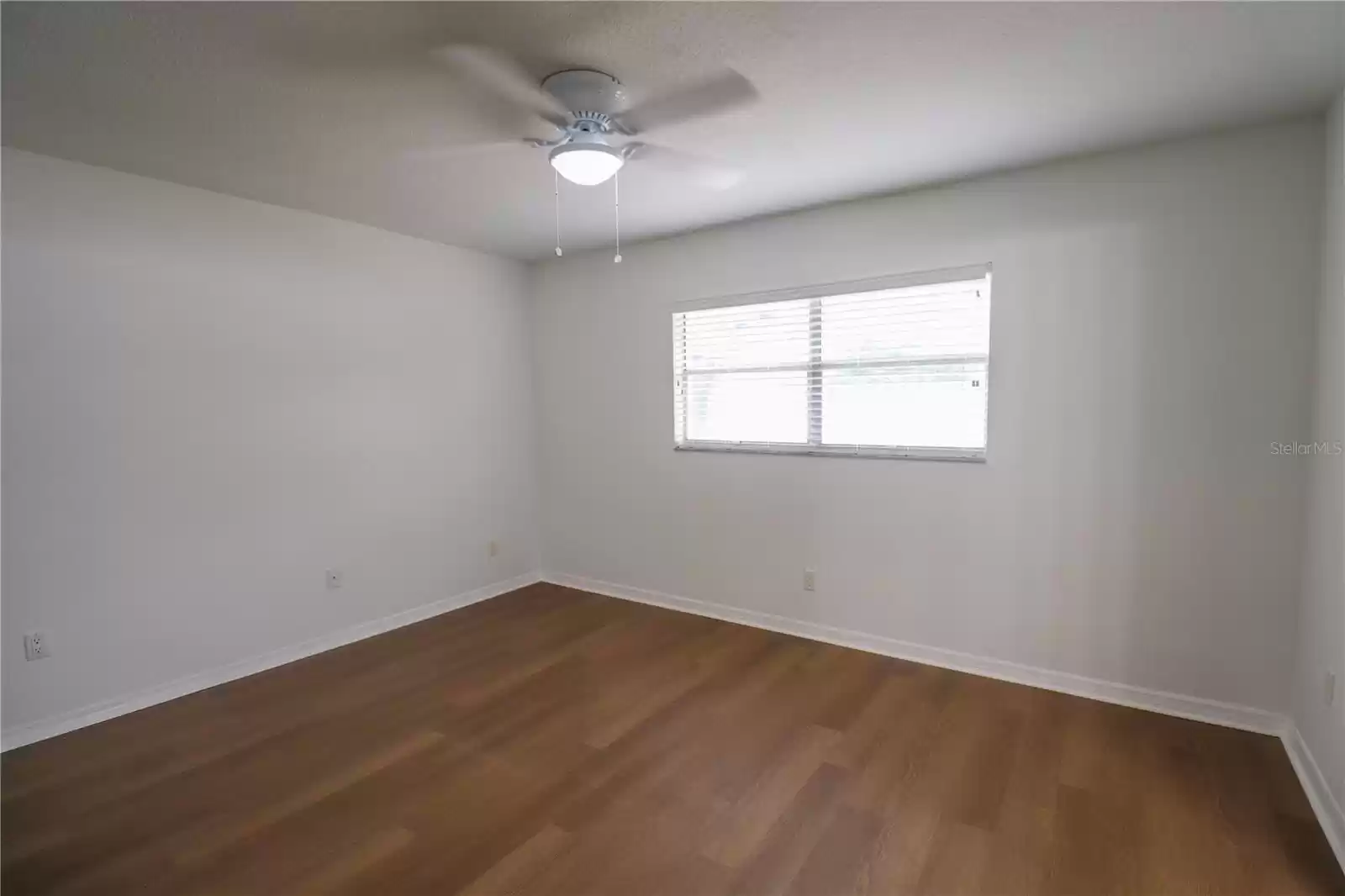 The primary bedroom with a ceiling fan.