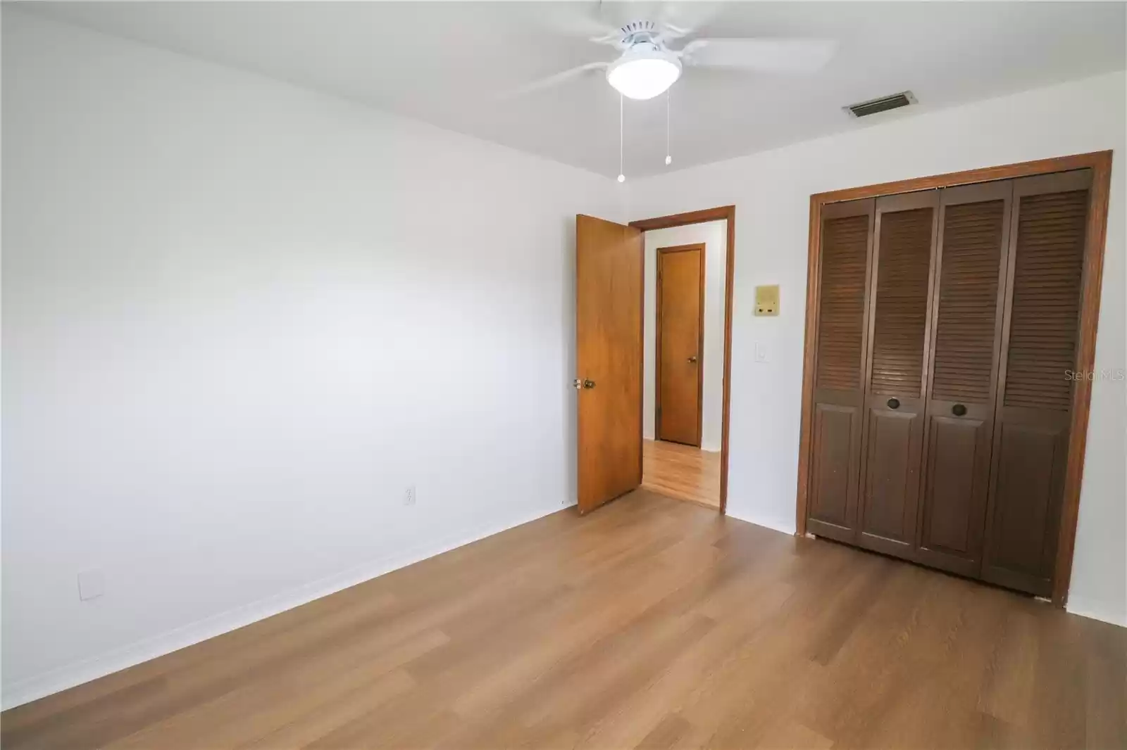 The view of the second  bedroom with closet.