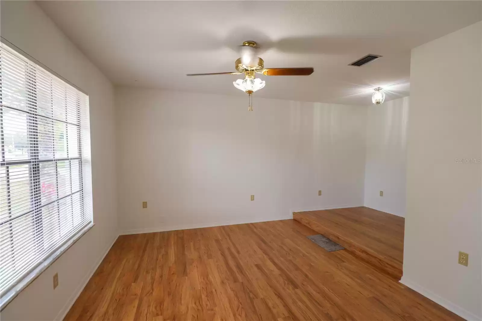 Formal Living room to your left with ceiling fans.