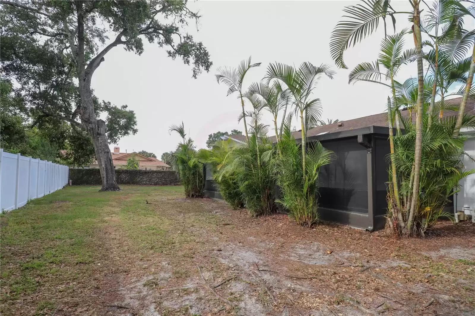 Large back yard with vinyl fencing around the property & patio.