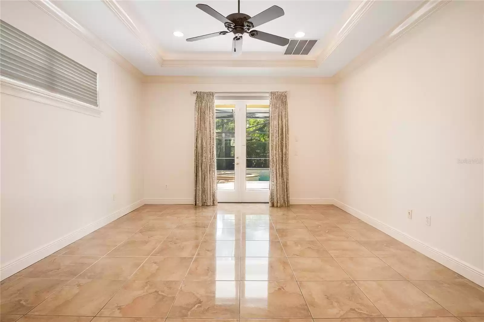 Downstairs primary bedroom with direct access to the pool.