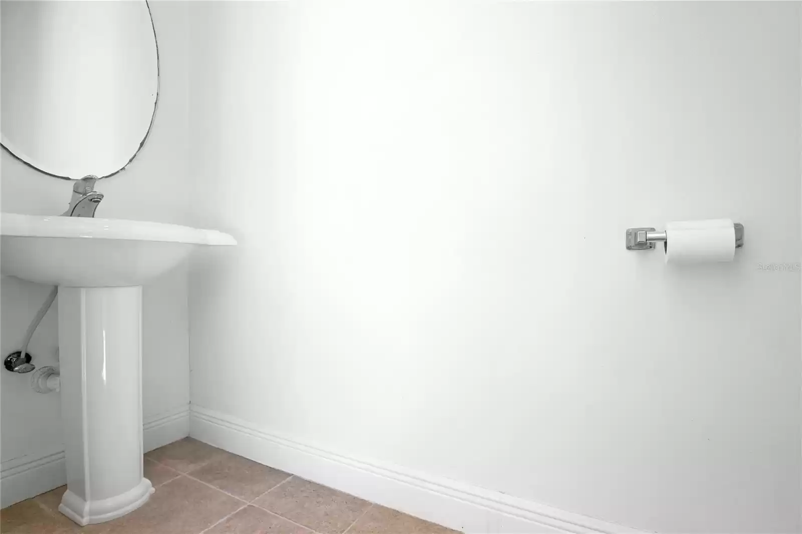 Half bathroom just off of the covered lanai exclusively accessed only from the lanai.