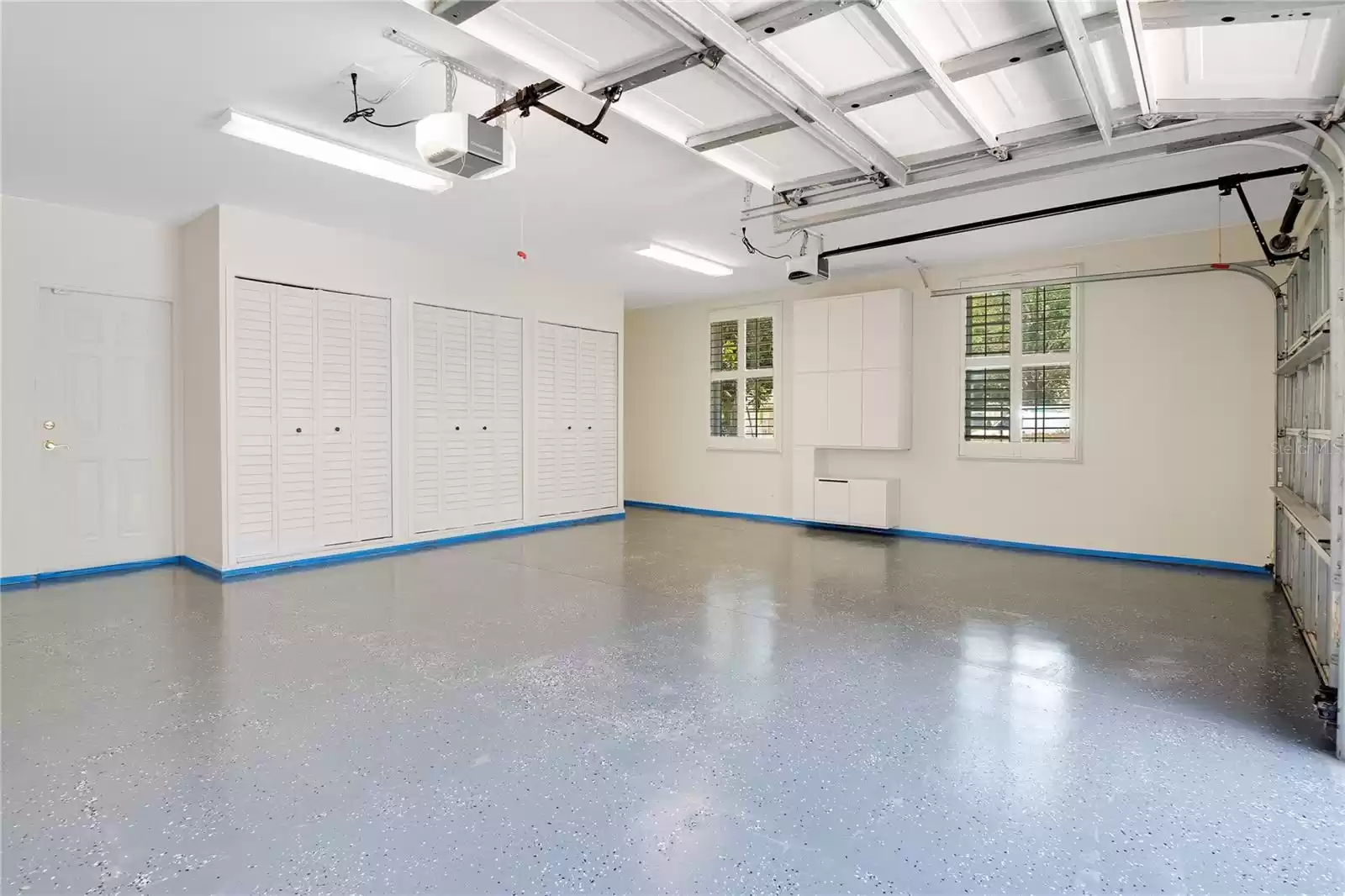 Large garage with epoxy flooring.