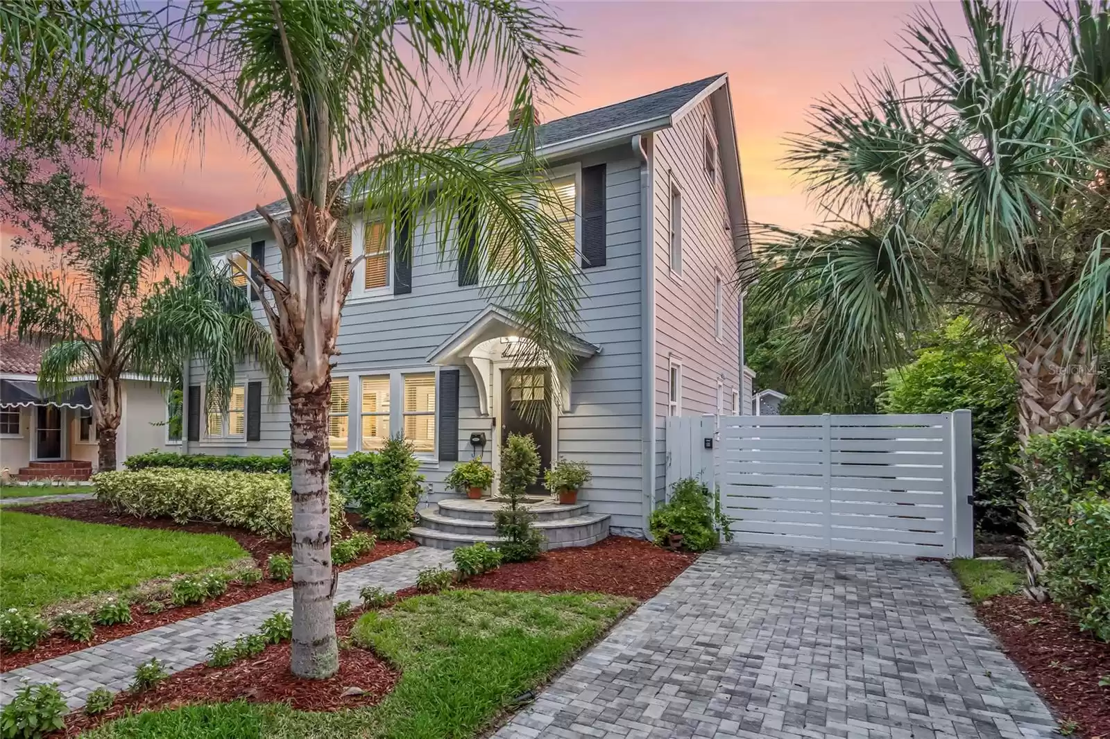 Front Exterior, Electric Gate, and Pavered Driveway to Detached Oversized 1 Car Garage