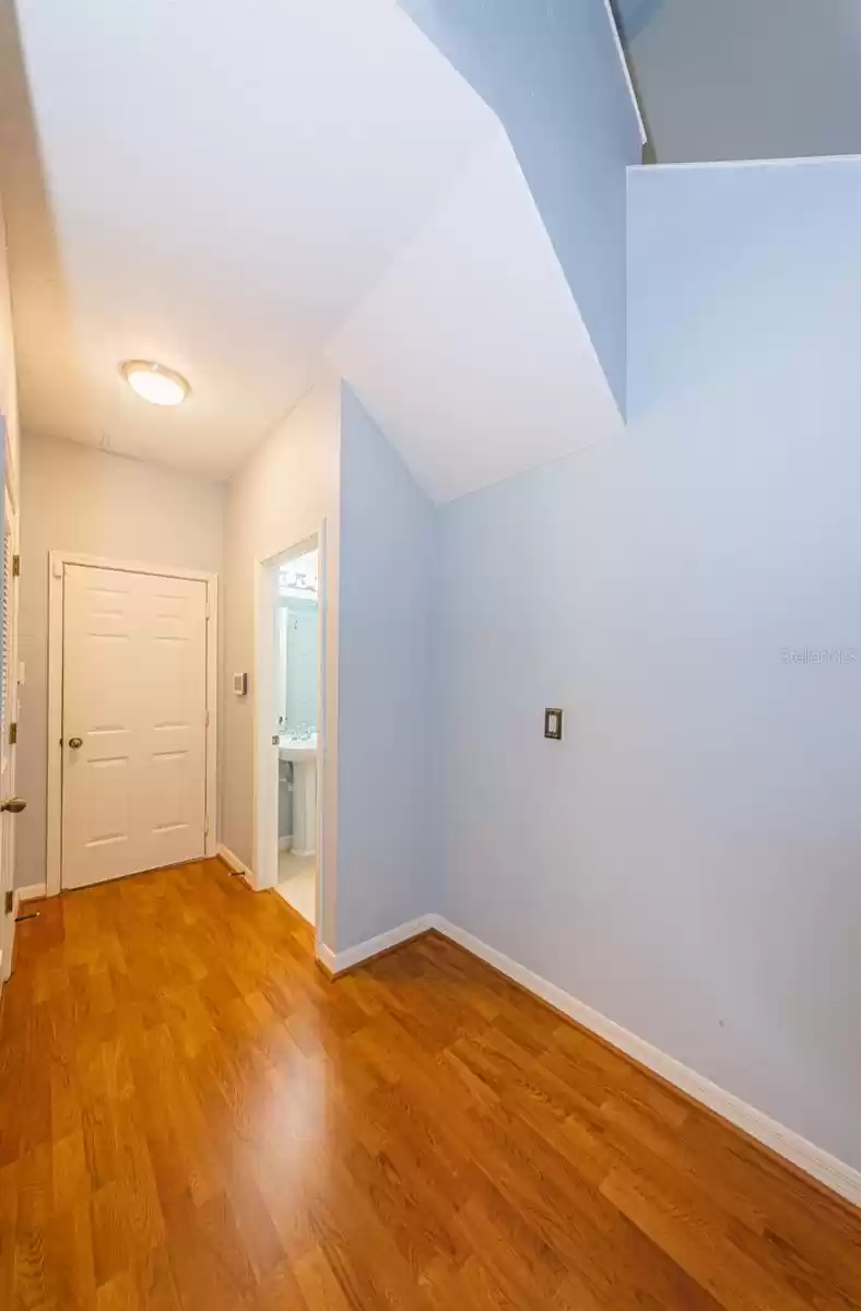 Hallway to 1/2 bathroom under stairs and garage entrance