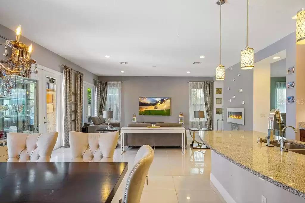 Second Dining Room Table with view into Kitchen, Living Room, Pool and Electric Fireplace