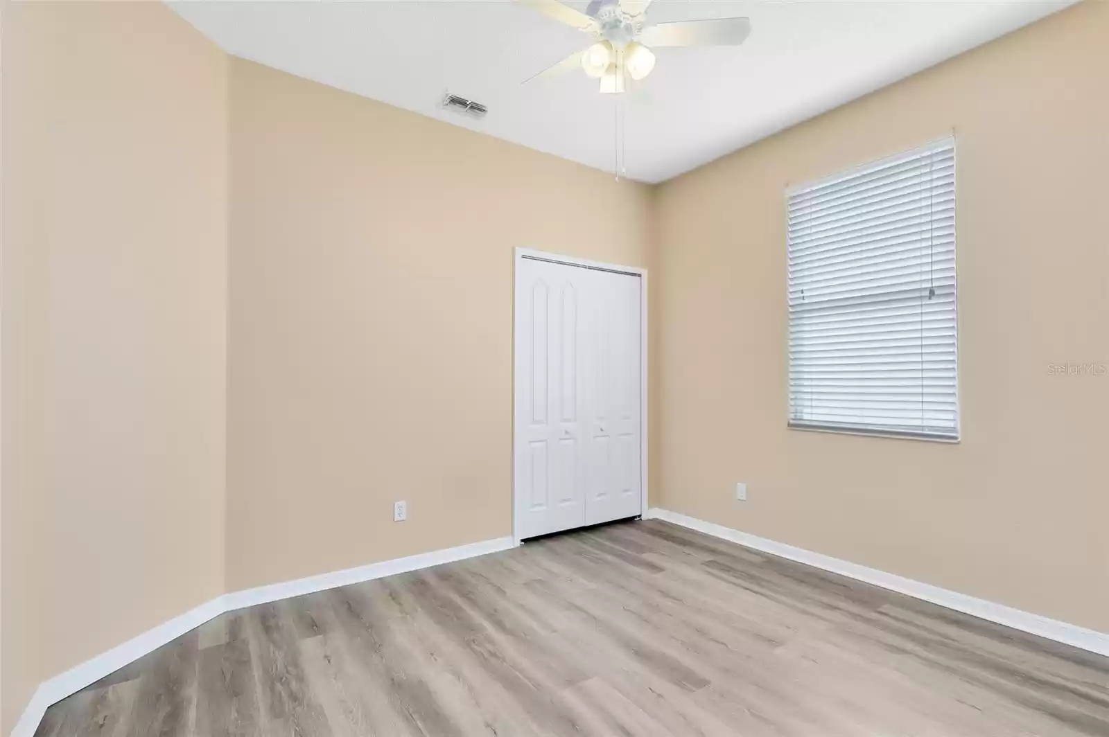 BEDROOM 2 DOWNSTAIRS WITH IT'S OWN FULL BATHROOM AND NEW LVP FLOORING