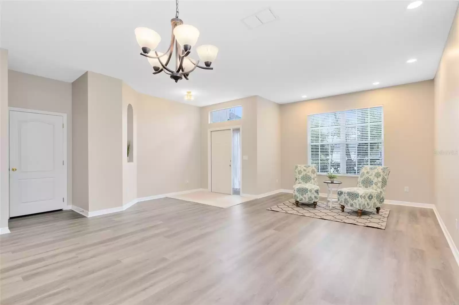 VIEW FROM THE DINING ROOM TO THE DINING ROOM AND FRONT ENTRY