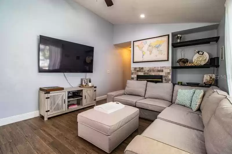 Family Room has a fireplace and lanai doors leading to the pool