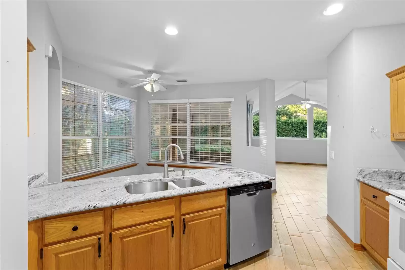 Upgraded granite in kitchen towards breakfast nook.