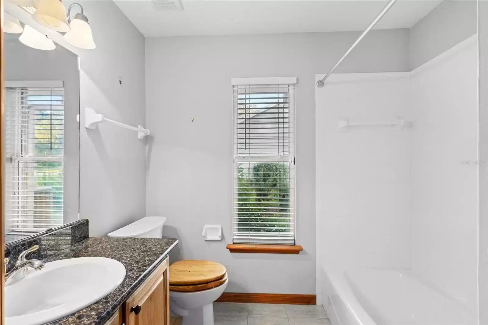 Guest bath with tub/shower combination.