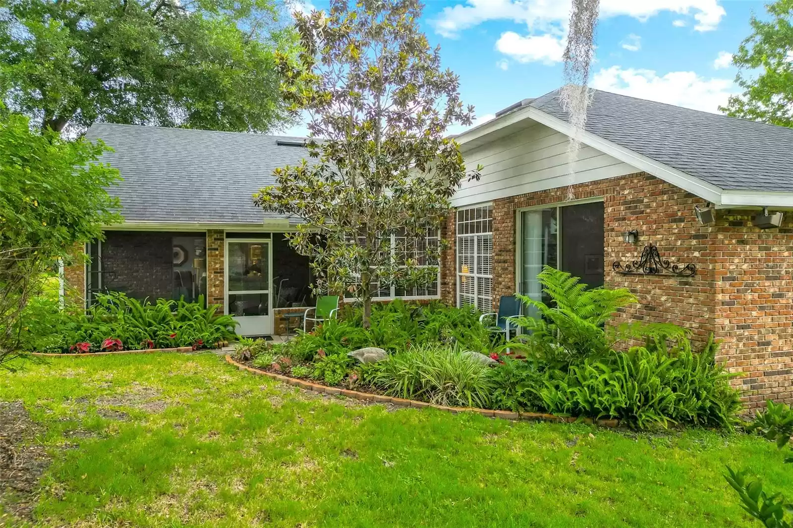 Beautiful rear landscaping makes the screened-in lanai perfect!