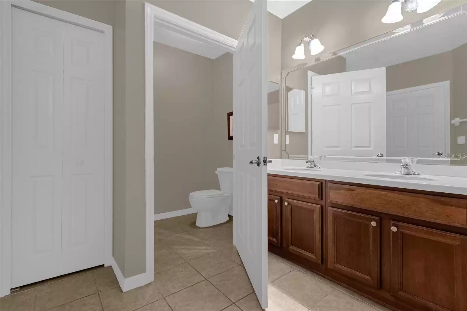 Left door linen closet. center door private toilet room. Doble sink master bathroom.