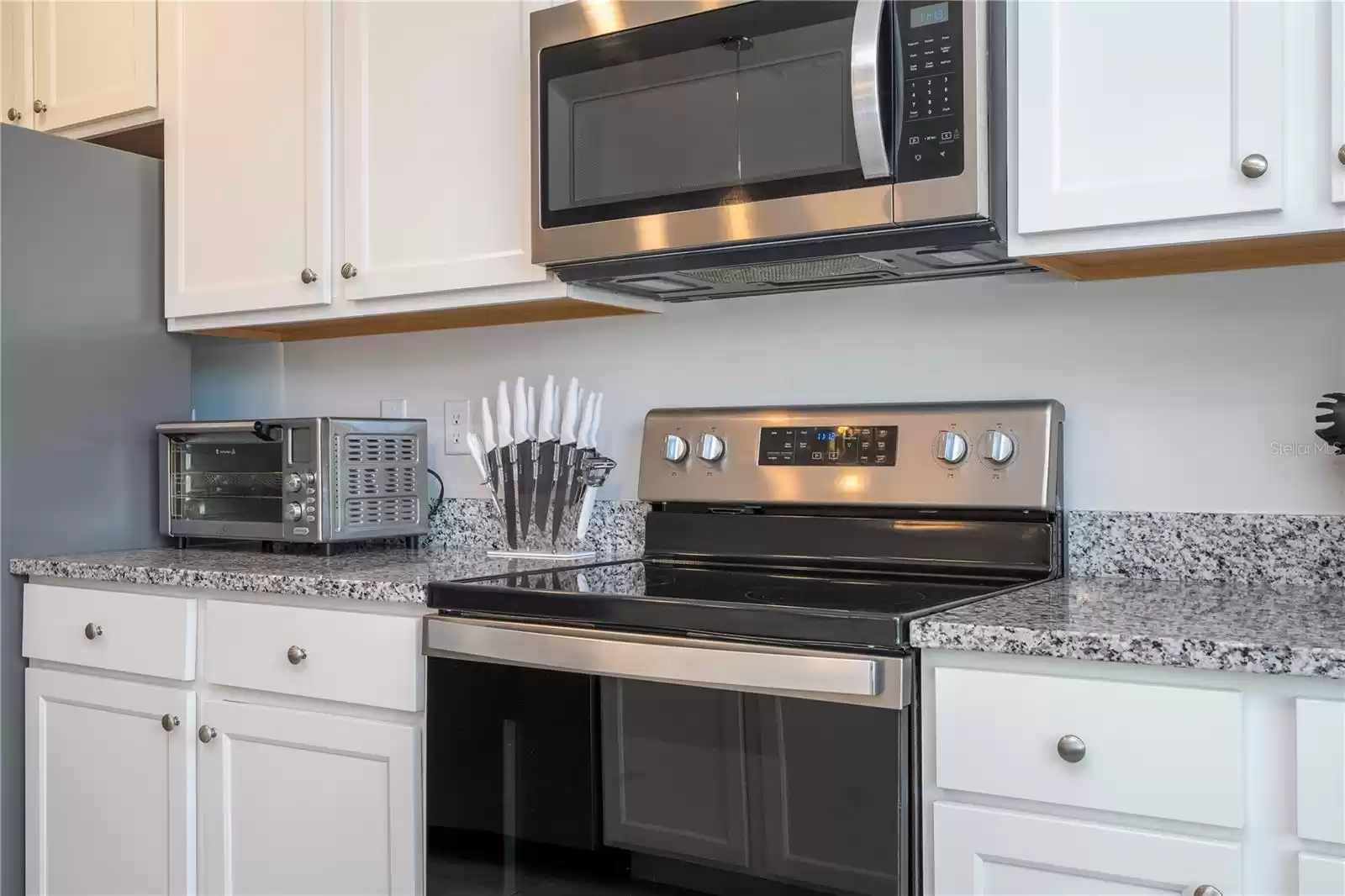 Granite Countertops and plenty of cabinets