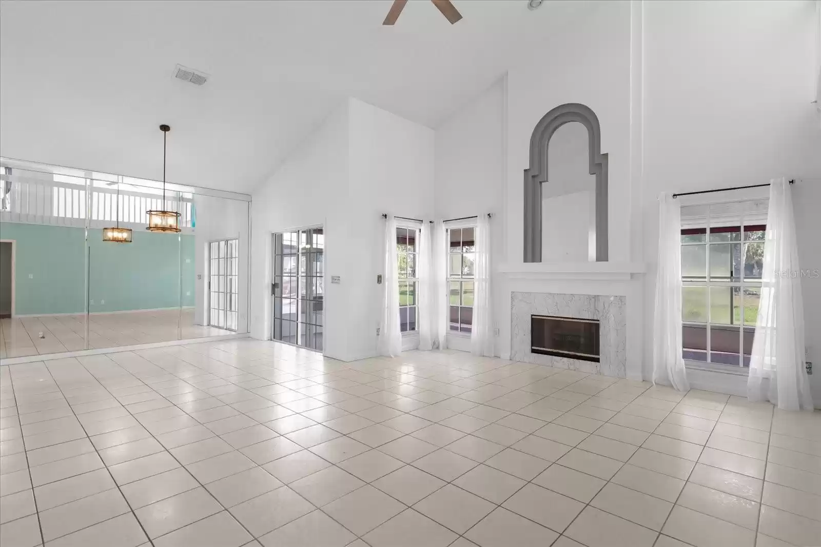 Looking from stair case to living room and dining room