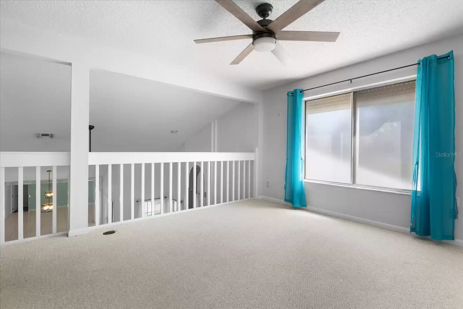 Loft, railing overlooks living area