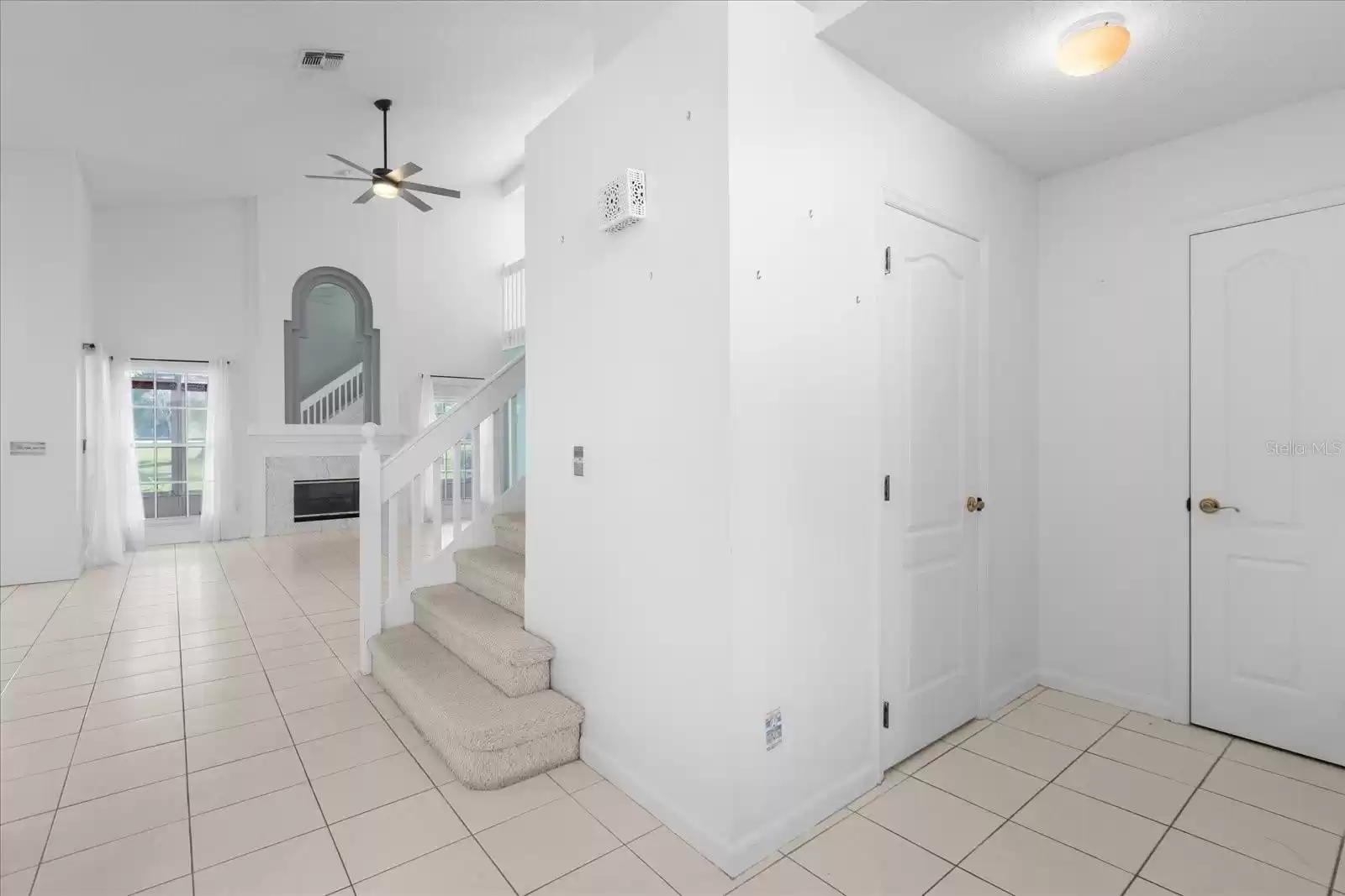 Entry living room ahead, half bath, closet and garage to right