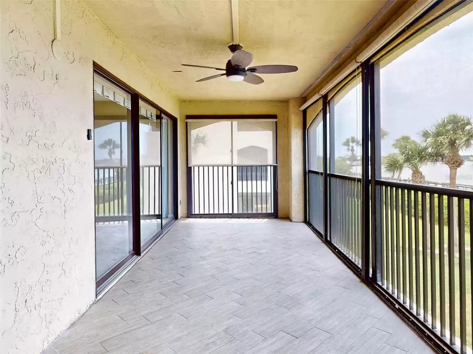 Tiled lanai with extra end unit view of water