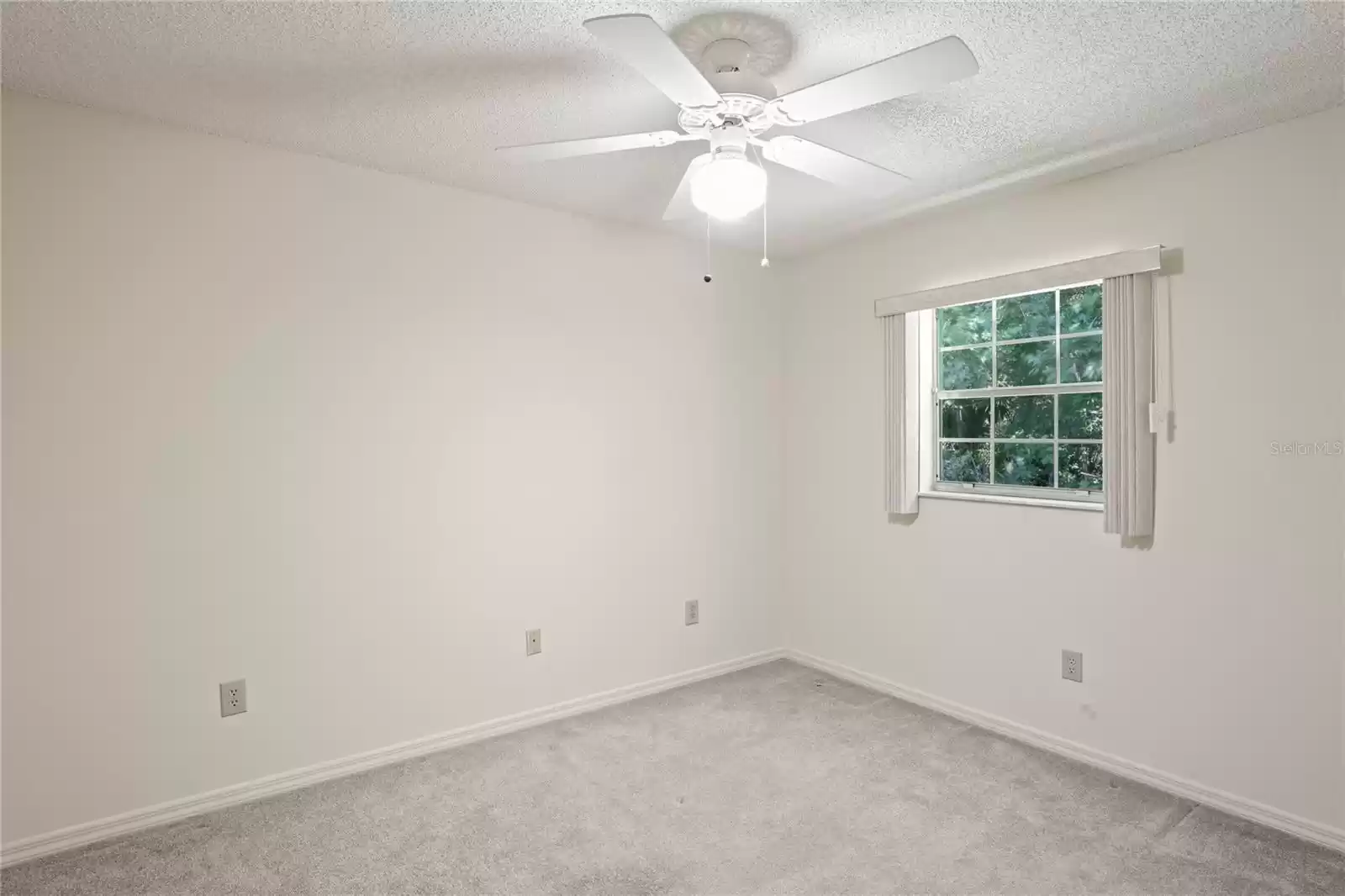 Guest bedroom has ceiling fan with light and a double size closet and a nice window.