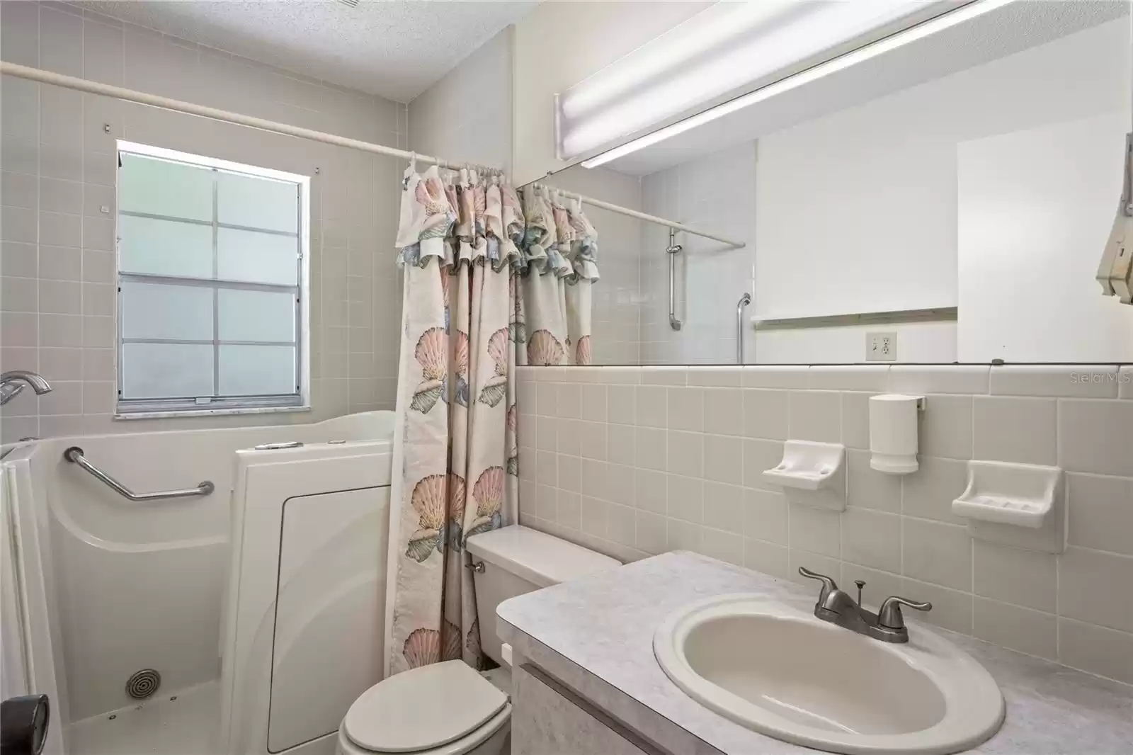 Guest bathroom, window, built in tub and single vanity