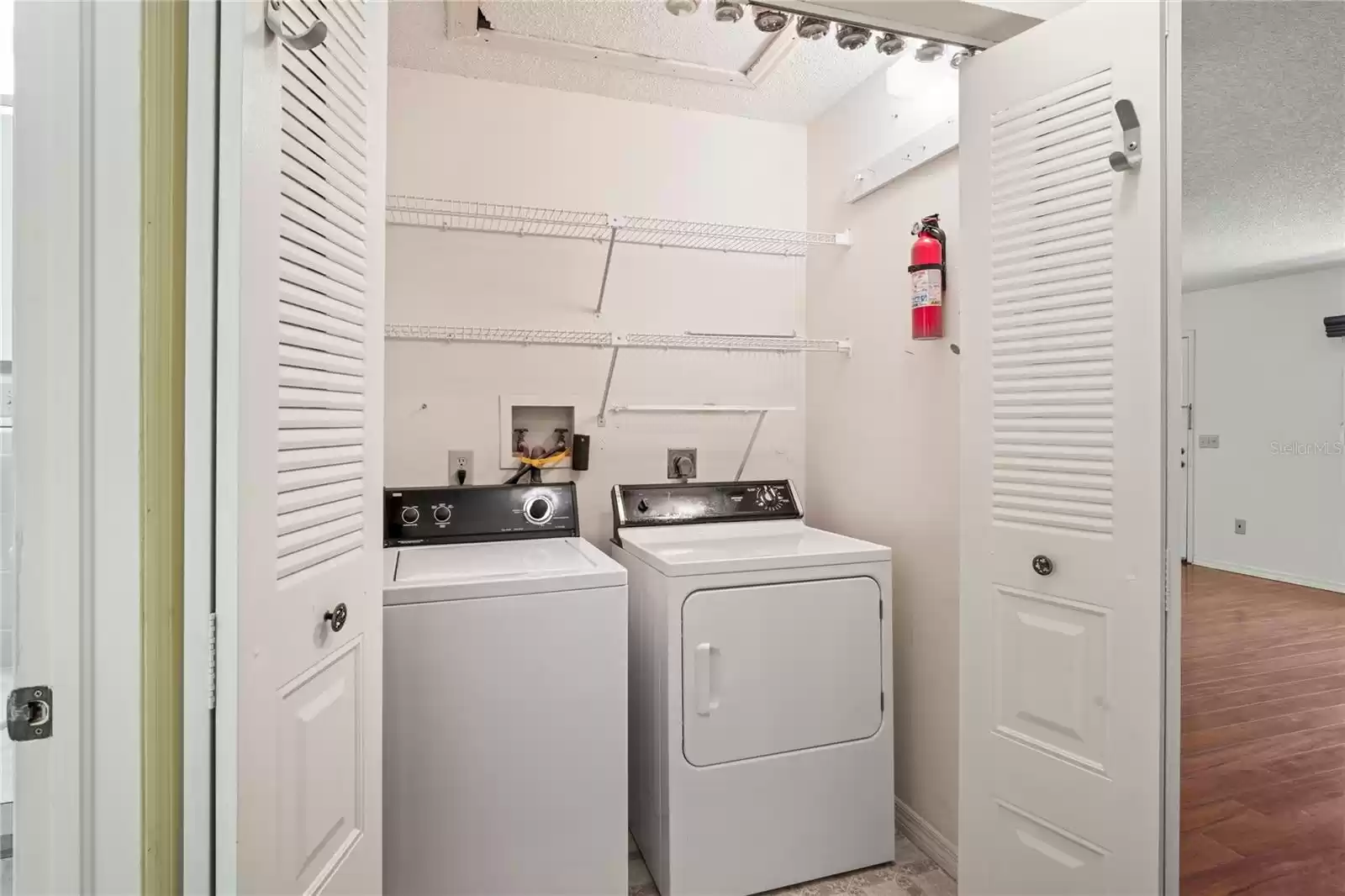 Laundry closet has the washer and dryer included., shelves and attict access.