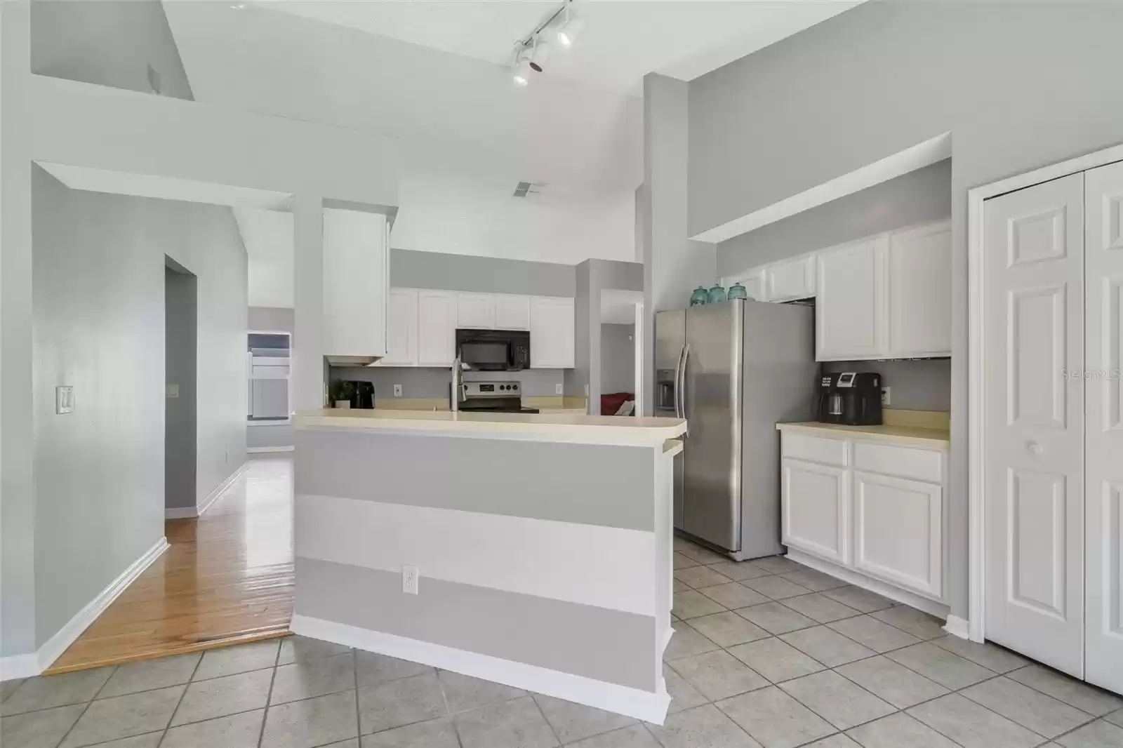 Perfectly situated in the heart of the home the kitchen offers a modern feel in the chic color palette, STAINLESS STEEL APPLIANCES and freshly painted cabinets.