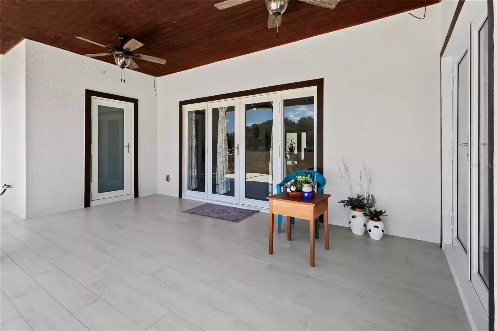 Covered back patio and entrance to half bath