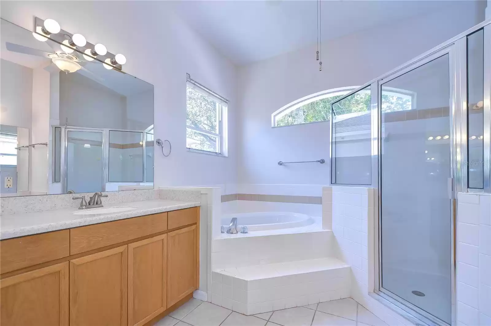 Lavish garden tub, an expansive shower, and his and hers vanities!