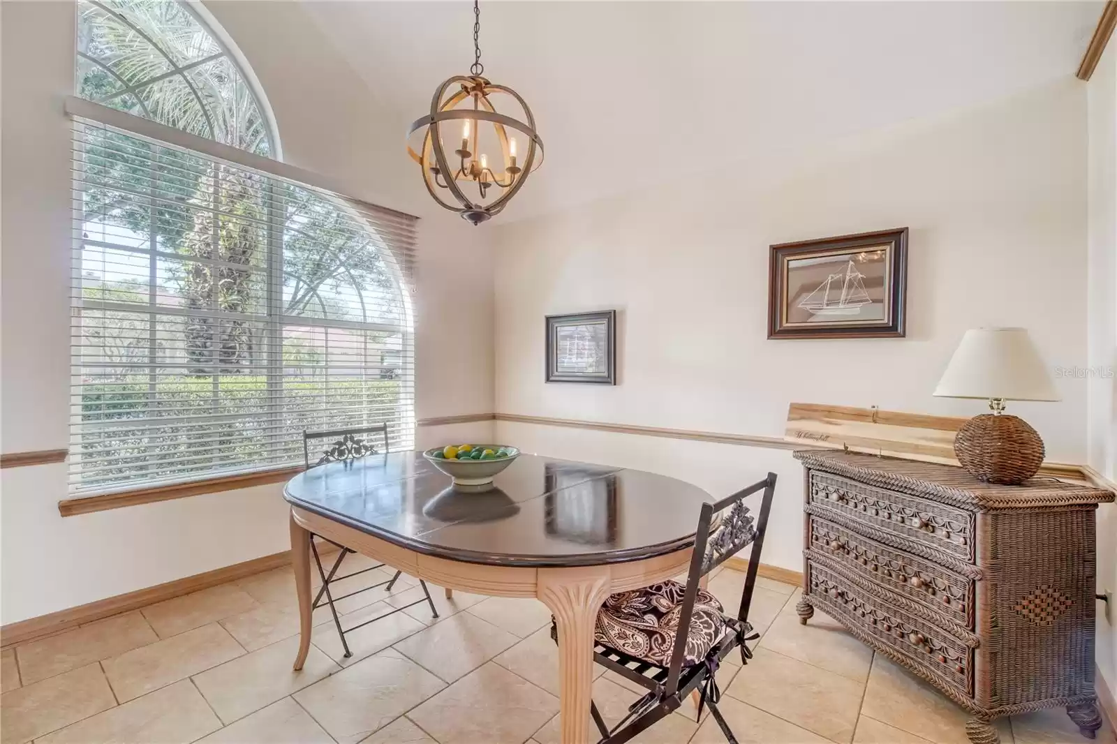 Open and airy dining room with chair rail.