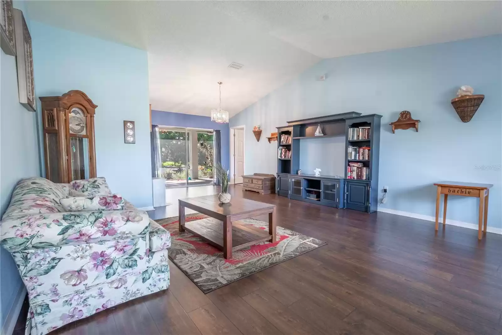 Vaulted ceilings and luxury vinyl floors create a light and air feel in the living room.